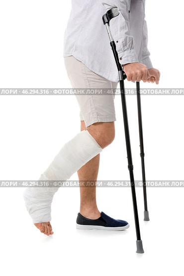 Young man with broken leg on white background. Стоковое фото, фотограф Pixel_shot / Фотобанк Лори