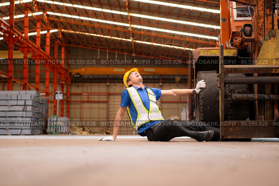 Young man working in a steel industry factory. He was critically hurt when a forklift ran over his leg and had to be transported to the hospital. Стоковое фото, агентство Ingram Publishing / Фотобанк Лори