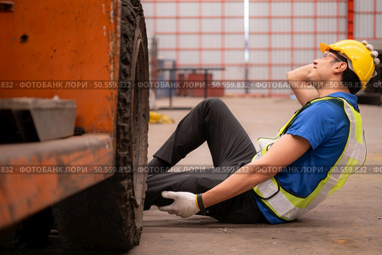 Young man working in a steel industry factory. He was critically hurt when a forklift ran over his leg and had to be transported to the hospital. Стоковое фото, агентство Ingram Publishing / Фотобанк Лори