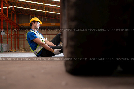 Young man working in a steel industry factory. He was critically hurt when a forklift ran over his leg and had to be transported to the hospital. Стоковое фото, агентство Ingram Publishing / Фотобанк Лори