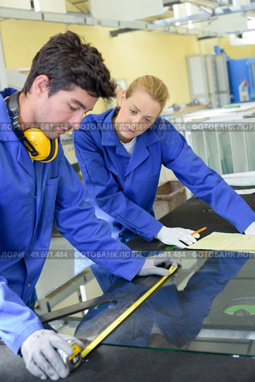 young qualified people forced to work at the factory. Стоковое фото, агентство Ingram Publishing / Фотобанк Лори