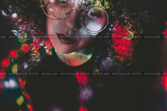 Young woman portrait illuminated by psychedelic lights. Стоковое фото, агентство Ingram Publishing / Фотобанк Лори