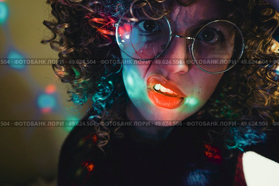 Young woman portrait illuminated by psychedelic lights. Стоковое фото, агентство Ingram Publishing / Фотобанк Лори
