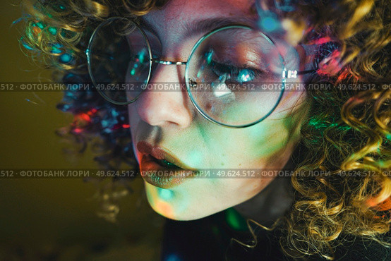Young woman portrait illuminated by psychedelic lights. Стоковое фото, агентство Ingram Publishing / Фотобанк Лори