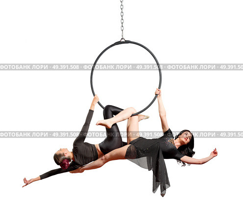 Young women doing gymnastic exercises on the hoop. Стоковое фото, агентство Ingram Publishing / Фотобанк Лори
