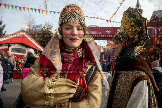 Женщины в традиционных русских нарядах на Манежной площади в центре города Москвы во время празднования Масленицы в рамках фестиваля "Зима в Москве", Россия. Редакционное фото, фотограф Николай Винокуров / Фотобанк Лори