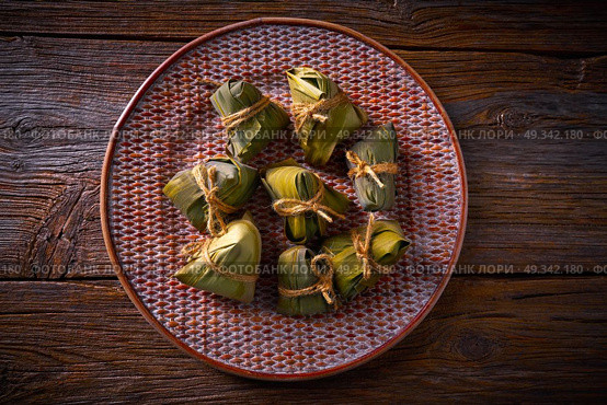 Zongzi Glutinous sticky Rice Dumplings recipe wrap with bamboo leaves asian food. Стоковое фото, агентство Ingram Publishing / Фотобанк Лори
